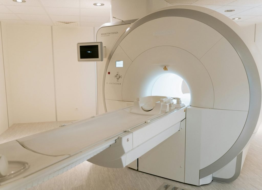 A state-of-the-art MRI scanner in a well-lit hospital room, ready for patient use.